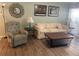 Living room with hardwood floors, neutral decor, and two sofas at 1601 Berwick Ct # B, Palm Harbor, FL 34684
