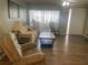 Living room with hardwood floors, comfy seating, and a coffee table at 1601 Berwick Ct # B, Palm Harbor, FL 34684