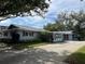 Cute light blue home with a carport and mature landscaping at 1601 Berwick Ct # B, Palm Harbor, FL 34684