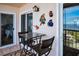 Small balcony with glass-top table and chairs at 19029 Us Highway 19 N # 9-706, Clearwater, FL 33764