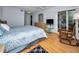 Bright bedroom with a comfortable bed and access to a balcony at 19029 Us Highway 19 N # 9-706, Clearwater, FL 33764