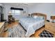 Main bedroom with king-size bed, water view, and a rocking chair at 19029 Us Highway 19 N # 9-706, Clearwater, FL 33764