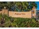 Imperial Cove community entrance with signage and landscaping at 19029 Us Highway 19 N # 9-706, Clearwater, FL 33764