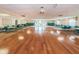 Large community room with hardwood floors, tables, and chairs at 19029 Us Highway 19 N # 9-706, Clearwater, FL 33764