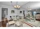 Bright dining room with glass table and seating for four, offering a view into the kitchen at 19029 Us Highway 19 N # 9-706, Clearwater, FL 33764