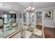 Dining area with glass table and chairs, offering a view into the kitchen and living room at 19029 Us Highway 19 N # 9-706, Clearwater, FL 33764