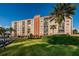 Condo building with palm trees and parking at 19029 Us Highway 19 N # 9-706, Clearwater, FL 33764