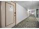 Carpeted condo hallway with apartment doors at 19029 Us Highway 19 N # 9-706, Clearwater, FL 33764