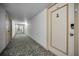Carpeted condo hallway with apartment doors at 19029 Us Highway 19 N # 9-706, Clearwater, FL 33764