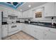 White kitchen with stainless steel appliances and ample counter space at 19029 Us Highway 19 N # 9-706, Clearwater, FL 33764