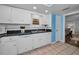 Kitchen features white cabinets, granite counters, and a double sink at 19029 Us Highway 19 N # 9-706, Clearwater, FL 33764