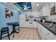 Well-equipped kitchen with white cabinets, granite countertops, and a breakfast bar at 19029 Us Highway 19 N # 9-706, Clearwater, FL 33764