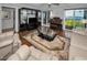 Living room with hardwood floors, comfortable seating, and water views at 19029 Us Highway 19 N # 9-706, Clearwater, FL 33764