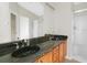 Bathroom with double sinks, granite countertop, and a separate shower at 30619 White Bird Ave, Wesley Chapel, FL 33543