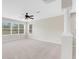 Bright living room with large windows and ceiling fan at 30619 White Bird Ave, Wesley Chapel, FL 33543