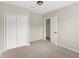 Well-lit bedroom with double door closet and neutral decor at 30619 White Bird Ave, Wesley Chapel, FL 33543