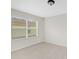 Spacious bedroom with large window and neutral carpeting at 30619 White Bird Ave, Wesley Chapel, FL 33543