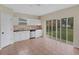 Kitchen with white cabinets, granite counters, and backyard view at 30619 White Bird Ave, Wesley Chapel, FL 33543