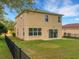 Two-story house with backyard, fence, and lawn at 30619 White Bird Ave, Wesley Chapel, FL 33543