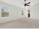 Main bedroom with ceiling fan and access to the en-suite bathroom at 30619 White Bird Ave, Wesley Chapel, FL 33543