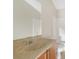 Bathroom with single sink, granite countertop, and a bathtub at 30619 White Bird Ave, Wesley Chapel, FL 33543