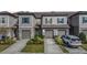 Two-story townhome with attached garage and landscaped front yard at 32013 Blue Passing Loop, Wesley Chapel, FL 33545