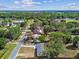 An aerial view showcases the home surrounded by lush greenery and neighborhood streets at 3414 Lindsey St, Dover, FL 33527
