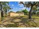 Spacious backyard with mature trees surrounding a well-maintained single-story home at 3414 Lindsey St, Dover, FL 33527