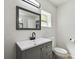 Clean bathroom with black fixtures, mirror, toilet, and modern vanity at 3414 Lindsey St, Dover, FL 33527