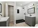 Modern bathroom with double vanity, black shower and storage at 3414 Lindsey St, Dover, FL 33527