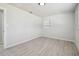 The bedroom is bright with a built-in shelf and wood-look flooring at 3414 Lindsey St, Dover, FL 33527