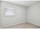 A bright bedroom featuring new flooring and a light-filled window at 3414 Lindsey St, Dover, FL 33527