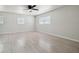 Spacious bedroom with light gray wood floors, ceiling fan, and bright natural light at 3414 Lindsey St, Dover, FL 33527