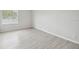 Bright bedroom features a window and new, light wood-look flooring at 3414 Lindsey St, Dover, FL 33527