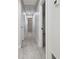 Hallway with light gray hardwood floors and bright white walls at 3414 Lindsey St, Dover, FL 33527