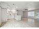 Open kitchen and living space includes white cabinets, and wood-look flooring that make this home feel warm and inviting at 3414 Lindsey St, Dover, FL 33527