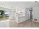 Bright kitchen with white cabinets, stainless steel appliances, and a breakfast bar overlooking a spacious backyard at 3414 Lindsey St, Dover, FL 33527