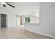 Open living space featuring a barn door, wood-look floors, and a view into the modern kitchen at 3414 Lindsey St, Dover, FL 33527