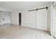 Open layout shows a sliding barn door, light flooring and neutral paint colors throughout the home at 3414 Lindsey St, Dover, FL 33527