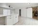 Open-concept layout with a kitchen island, barn door, and wood-look flooring throughout at 3414 Lindsey St, Dover, FL 33527