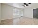 Spacious living area with a large window, wood-look floors, and a ceiling fan for a comfortable atmosphere at 3414 Lindsey St, Dover, FL 33527