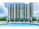 Resort-style pool area with comfortable lounge chairs and umbrellas at 345 Bayshore Blvd # 808, Tampa, FL 33606