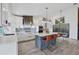 Bright kitchen with sleek white cabinets, a large island with seating, and stainless steel appliances at 3603-B Avenida Madera, Bradenton, FL 34210