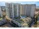 Stunning aerial view of luxurious high-rise condos with a sparkling blue pool and lush landscaping at 450 Knights Run Ave # 407, Tampa, FL 33602