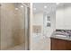 Modern bathroom featuring dual vanities, a soaking tub, and a glass-enclosed shower at 450 Knights Run Ave # 407, Tampa, FL 33602