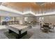 Entertaining game room featuring a pool table, bar area, and comfortable seating for residents at 450 Knights Run Ave # 407, Tampa, FL 33602