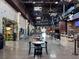 Interior view of hall with dining tables, high ceilings and food vendors on each side at 450 Knights Run Ave # 407, Tampa, FL 33602