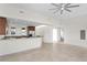 Open concept living area with kitchen, tiled floor, and ceiling fan at 450 Knights Run Ave # 407, Tampa, FL 33602