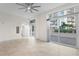 Open living room with tiled flooring, ceiling fan, and sliding glass doors at 450 Knights Run Ave # 407, Tampa, FL 33602