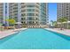 Luxury pool at the base of high-rise condos with sundeck and lounge chairs, ideal for relaxation and social gatherings at 450 Knights Run Ave # 407, Tampa, FL 33602